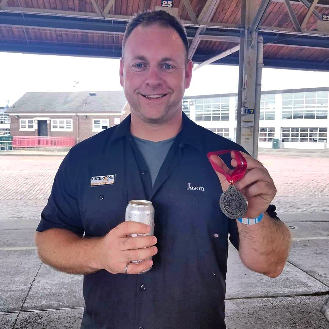 Owner, Jason Havens, shows off a silver medal awarded to Rusty Nickel Brewing by the New York State Brewers Association for their beer Slice O' Havens Orange-Vanilla Imperial Cream Ale.