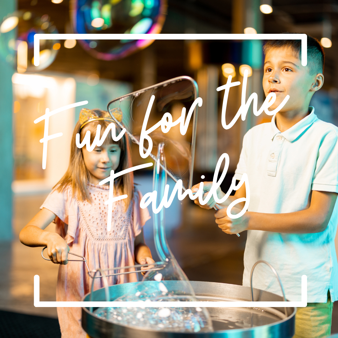 "Fun for the family", two kids play with bubbles in a museum exhibit