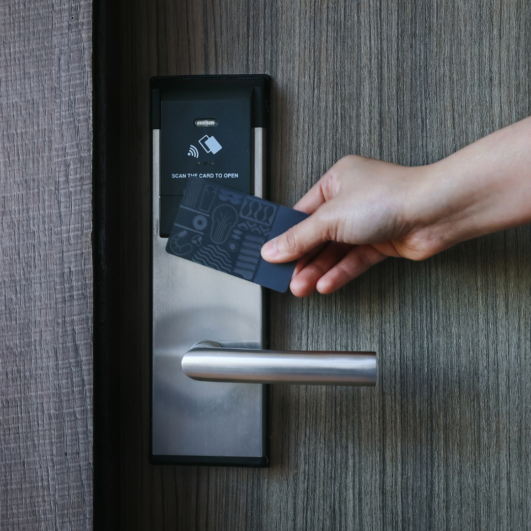 A room key is scanned at a hotel room door