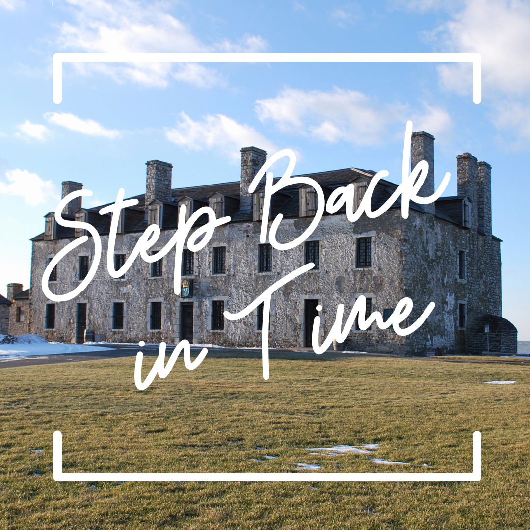 Old For Niagara, a stone building, sits on a grassy hill. melting snow can be seen on the front lawn. text reads "Step back in time"