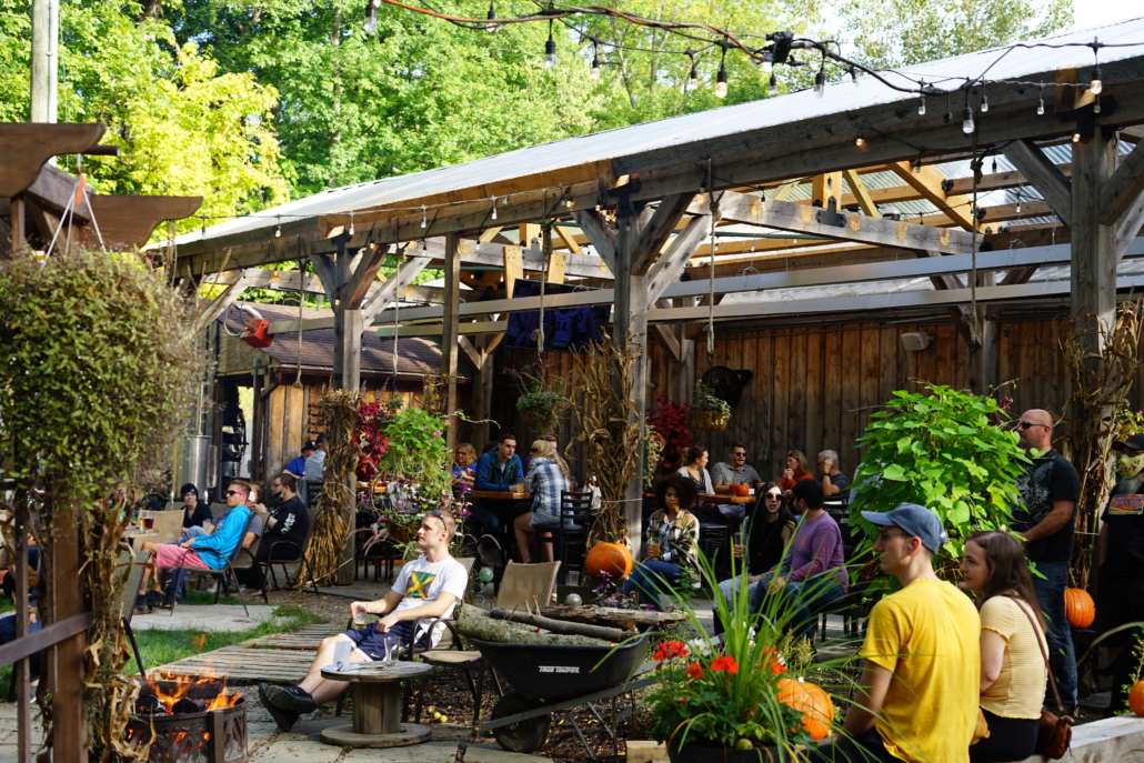 A view of the garden at Rusty Nickel Brewing. A large timber pergola lines the back of the building.
