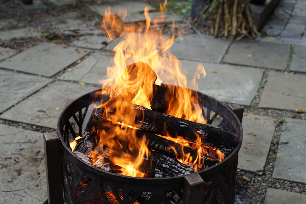 a lit firepit burns wood