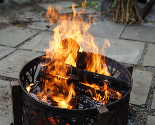 a lit firepit burns wood
