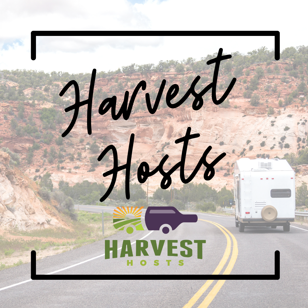 A camper van drives down a winding road in the desert. "Harvest Host" is written across the image.