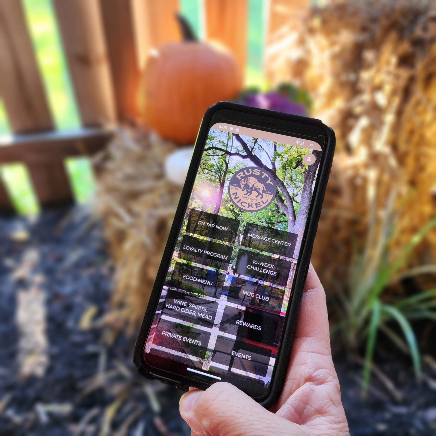 Hand holding phone with app display