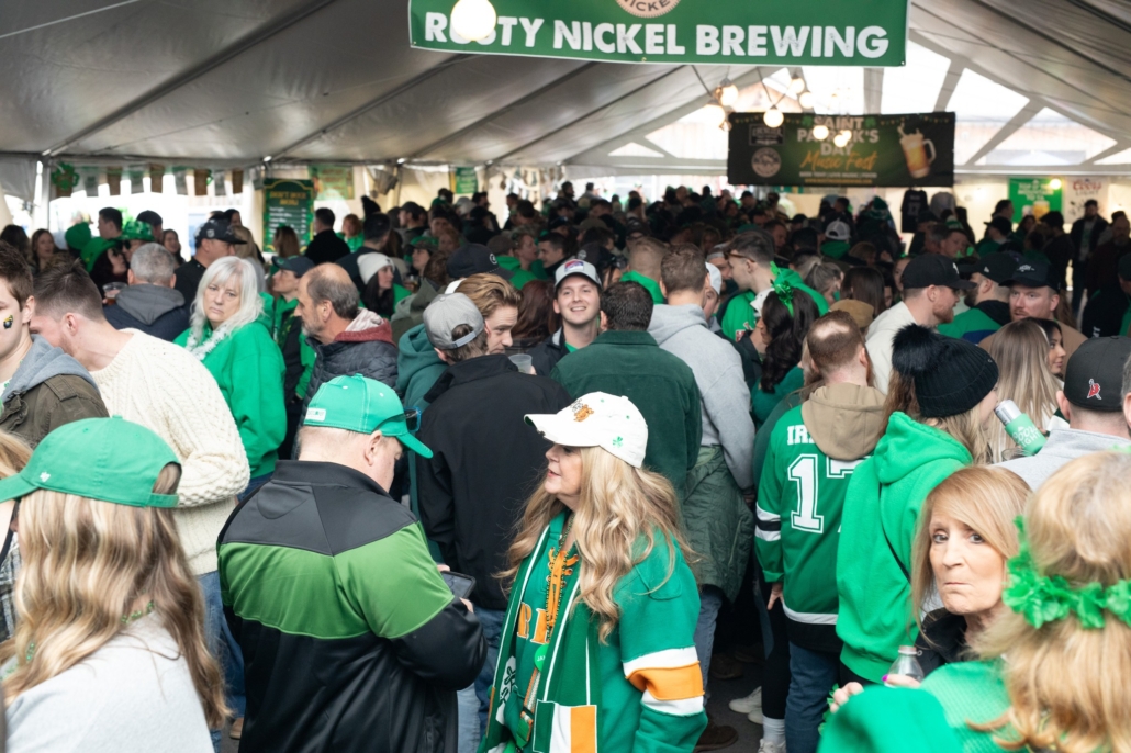 Crowd celebrating in green attire.